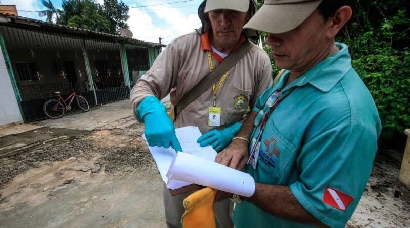 agentes do combate à dengue em pé realizando leitura de dados